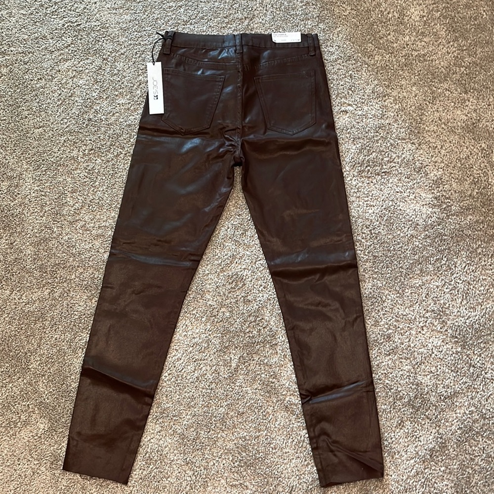 Faux leather dark burgundy/chocolate high rise ankle pants with a raw hem.